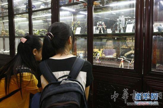 7月2日,在懷舊玩具展上,兩位觀眾在擺滿變形金剛玩具的展柜前參觀。新華社記者 方喆 攝